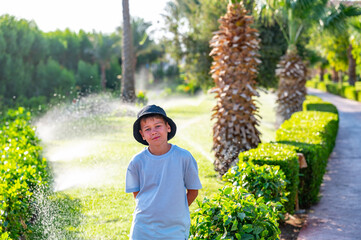 A boy on the beach in a 
 panama hat
