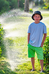 A boy on the beach in a 
 panama hat