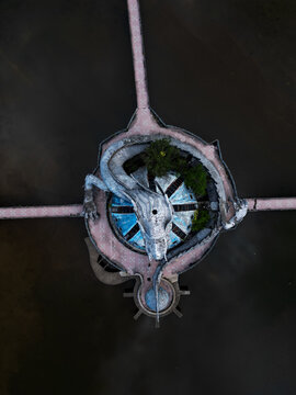Aerial view of a striking white dragon statue coiled around a circular platform on the Perfume River, Hue, Hue City, Vietnam.