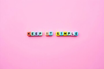 Keep it simple slogan words and letters spelled with colorful alphabet bead blocks.