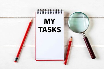 MY TASKS text on notebook on a white wooden background , business concept.