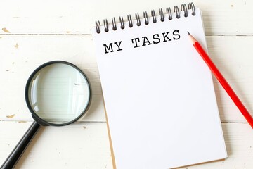 MY TASKS text on notebook on a white wooden background , business concept.