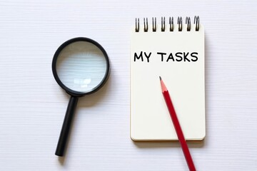 MY TASKS text on notebook on a white wooden background , business concept.