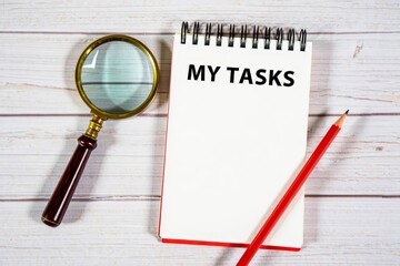MY TASKS text on notebook on a white wooden background , business concept.