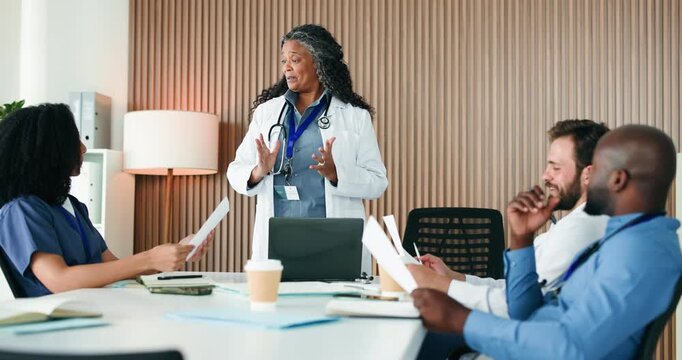 Paperwork, manager or doctors writing in boardroom, admin or operational planning for medical practice. People, healthcare committee or clinic director with policy update for team, meeting or laptop