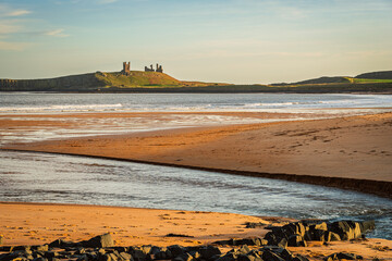 Dunstanburgh Castle dominates Embleton Bay, which is a long stretch of sand overlooked by the dramatic ruins of Dunstanburgh Castle located on the North Sea coast in the National Landscape (AONB)