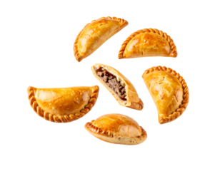 Golden baked empanadas with braided edges and one cut open showing minced meat filling, savory hand pie cutout on isolated background