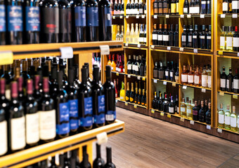 Background of wine bottles on shelves in liquor store