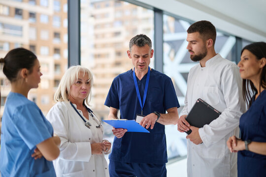 Medical team discusses patient care strategies in a modern hospital setting during the day