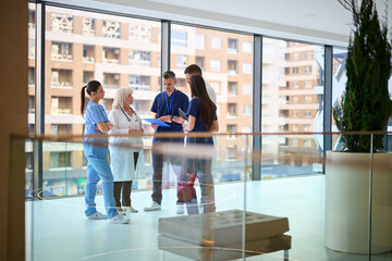 Medical staff discuss patient care in modern hospital setting during daytime