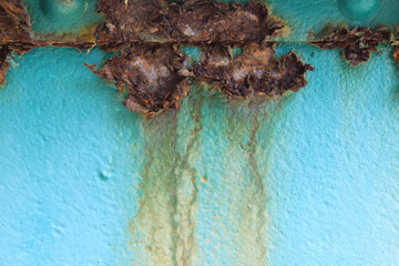 The iron background is old, dirty, and heavily rusted.