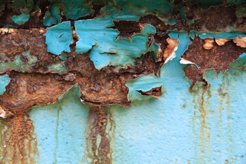 The iron background is old, dirty, and heavily rusted.