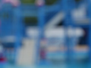 Blurred image of a blue water park or swimming pool.