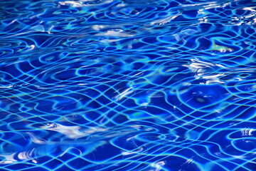 The surface of blue swimming pool water.