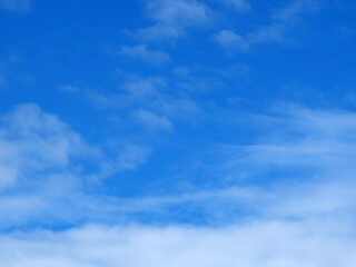 A bright blue sky background with beautiful clouds; a bottom-down, wide-angle view.