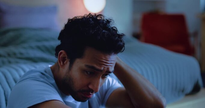 Night, decision and man in bedroom, stress and worry with insomnia, ptsd and overwhelmed. Evening, home or sad person with depression, emotion or thinking with mental health, wake up or concerned