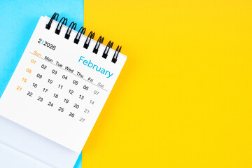 February 2026, Monthly desk calendar for 2026 year on yellow and blue background.
