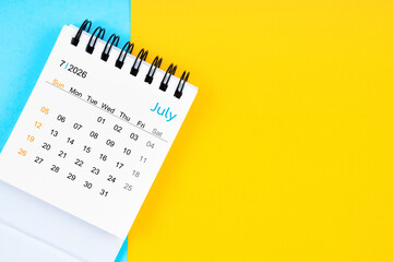 July 2026, Monthly desk calendar for 2026 year on yellow and blue background.
