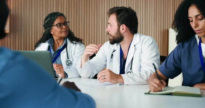Man, discussion and doctors in meeting, healthcare and feedback for hospital schedule. People, medical service and employees in clinic, agenda or review for medicare support and time management