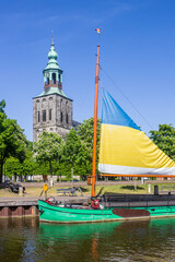 Historic wooden ship in front of the church tower of Nordhorn, Germany