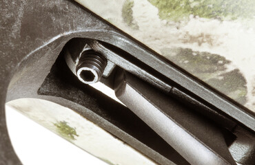 Bolt in front of a gun trigger to adjust its weight