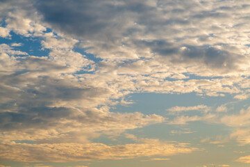 High-altitude cirrus clouds drifting across the calm evening sky.