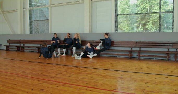 The girls' team rests after a volleyball game. .