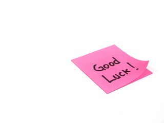 Good luck message hand written on pink paper on white background. positive vibes, motivation, and support concept
