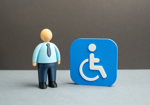 An office worker and a symbol of disability. Workplaces and support for people with disabilities. Inclusive employment, reasonable accommodations and equal opportunity policies in modern organizations