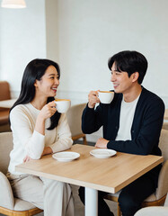 Happy asian couple drinking coffee in cafe. 