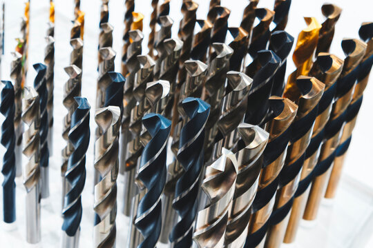 various types of drill bits milling cutter. display is organized and bits are arranged in way that makes it easy to see the differences between them