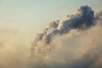 Air pollution by smoke coming out of factory chimneys, global warming, environmental problems.