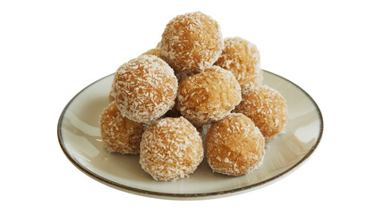 Delicious golden coconut laddus or energy balls piled high on a white plate
