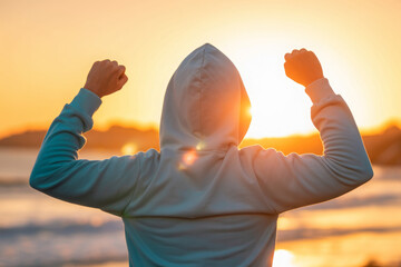 Back view of strong motivated woman celebrating workout goals towards the sun. Morning healthy training success. 
