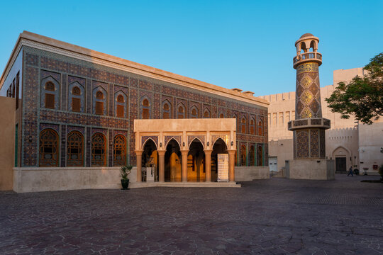 Doha, Qatar - 05 November 2025: View of the vibrant tiled facade of the Sheikh Abdullah Bin Zaid Al Mahmoud Islamic Cultural Center, its minaret reaching towards the clear blue sky.