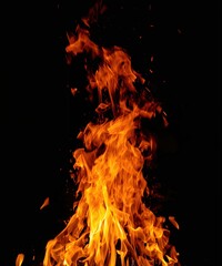 Fototapeta premium Dramatic fire blaze with layered flames and glowing embers, isolated background for heat and hazard visuals.