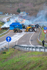 Tractors and smoke blocking a road in Spain the concept of an agricultural strike
