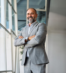 A man in a blue shirt is standing in office, businessman portrait