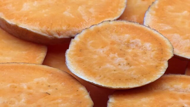 Raw sweet potato slices with rich texture and natural vibrant hues