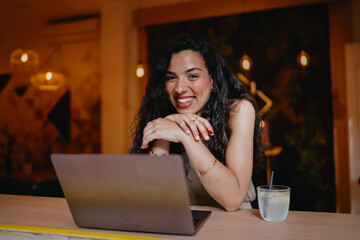 Freelancer radiates confidence in tech-enabled work, merging joyful presence and intuitive digital focus in remote productivity flow.