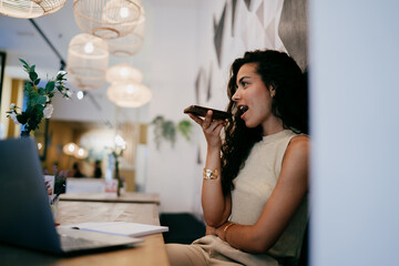 Freelancer passionately records voice message, engaging in dynamic speech task that illustrates...