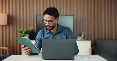 Businessman, laptop or tablet in office with review for finance statistics, audit check or report. Person, typing or reading in workplace with tech, computer or financial data analysis for accounting - Powered by Adobe