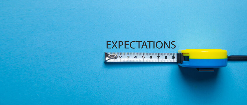 Tape measure with a word Expectations the blue background.