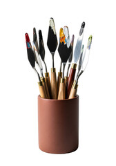 Hyperdetailed macro product shot of professional stainless steel palette knives with dried vibrant oil paint residue, clustered in a terracotta holder on a pure white backdrop. Concept of skilled