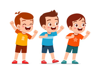 Three happy young boys cheering with arms raised fists clenched smiling in a joyful mood celebrating success