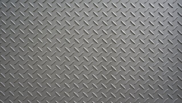 Gray metallic diamond plate texture with repetitive raised pattern