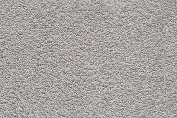 Rough white wall surface close up. Cloud Dancer color of the year 2026. Textured background for interior design and architectural concept.