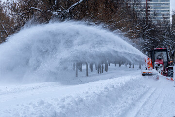 A tractor is plowing snow in a park
