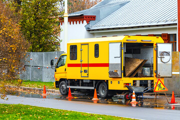  yellow city utility vehicle. repair of city infrastructure. emergency service