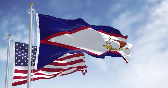 The American Samoa flags waving with american flag on a clear day